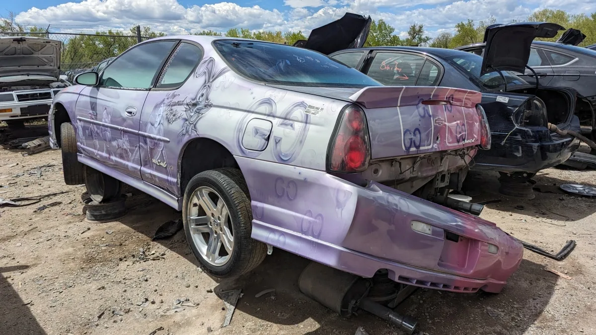 "Customized 2002 Chevrolet Monte Carlo with Disney and Gucci Artwork: A Unique Junkyard Gem"